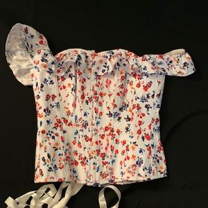 Corset story floral corset with ruffle off the shoulder detail. Lace up back.